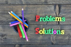 Problems and Solutions word on wooden table